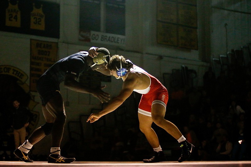 Bradley Central's Tyrone McDonald, left, and Baylor's Omar Alvarez wrestle during the 170-pound match Thursday night at Jim Smiddy Arena in Cleveland, Tenn. Alvarez won 2-0 to help the Red Raiders to a 49-15 victory. / Staff photo by C.B. Schmelter