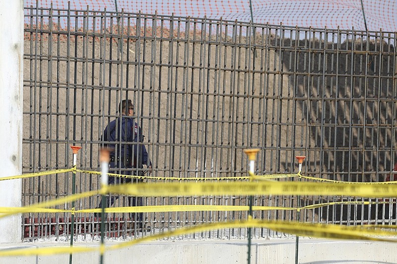 A McAllen K-9 police officer walks past rebar that will make up the border wall before DHS Acting Homeland Secretary Chad Wolf tours and speaks to the local media at the border wall under construction on Thursday, Nov. 21, 2019, south of Donna, Texas./The Monitor via AP)


