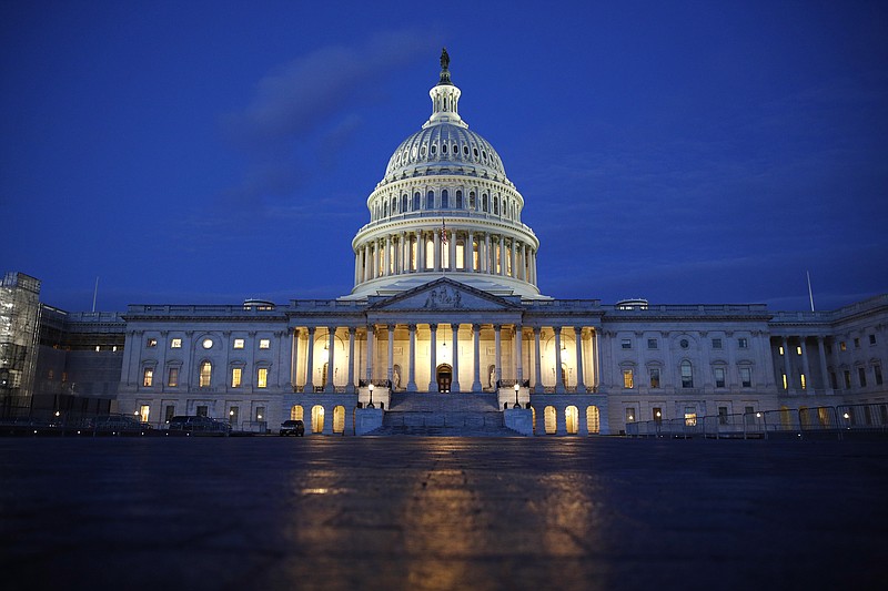 Light shines on the U.S. Capitol dome in Washington, early Wednesday, Dec. 4, 2019, prior to scheduled testimony from Constitutional law experts at a hearing before the House Judiciary Committee on the constitutional grounds for the impeachment of President Donald Trump. (AP Photo/Patrick Semansky)
