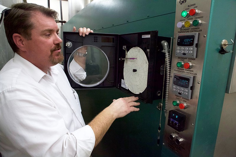 Staff photo by Wyatt Massey / Walter Crox Jr., funeral director at Covenant Funeral Home & Crematory, explains how staff record the temperature of the crematory on Dec. 11, 2019.