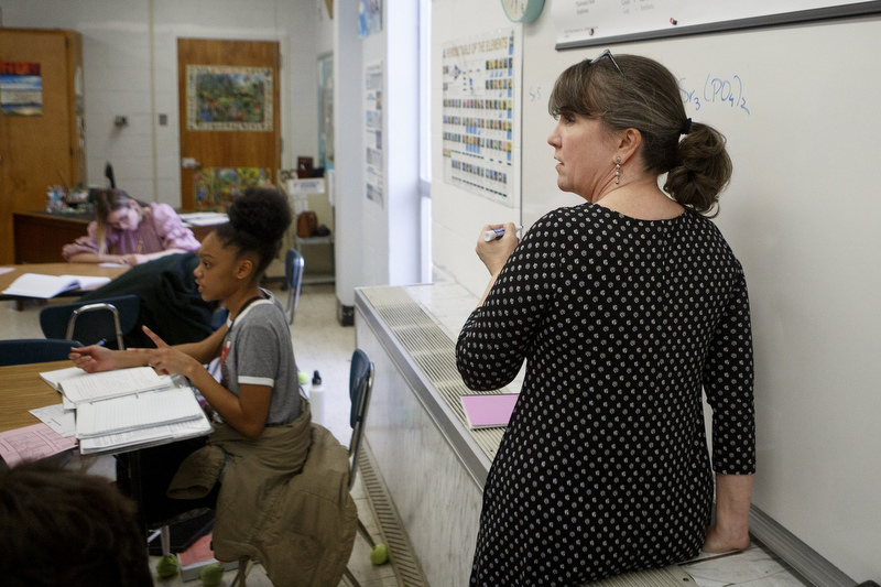 Staff photo by C.B. Schmelter / Science teacher Kelley Kuhn writes on a white board before a test review at Chattanooga Center for Creative Arts on Tuesday, Dec. 10, 2019 in Chattanooga, Tenn.