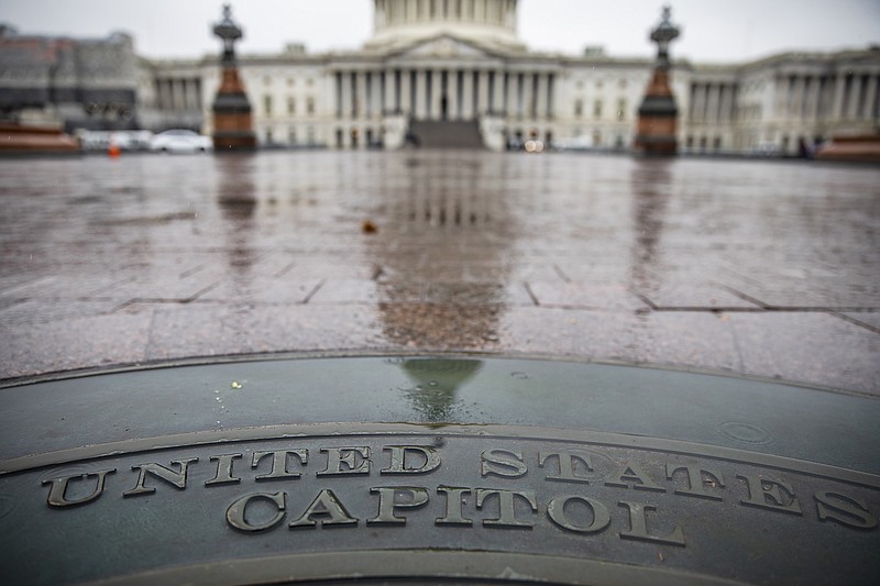 Samuel Corum, The New York Times / The U.S. Capitol is reflected in a wet walkway Friday, the day the House Judiciary Committee voted along party lines for the articles of impeachment of President Donald Trump. Partisanship is rampant in today's politics, but former elected officials like Tennessee's Zach Wamp seek bridges to fix that.