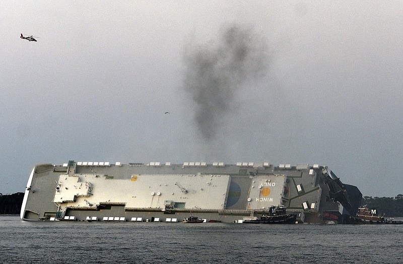 FILE - In a Sunday, Sept. 8, 2019 file photo, smoke rises from a cargo ship that capsized in the St. Simons Island, Georgia sound. Crews have finished draining all of the fuel from an overturned cargo ship three months after it capsized off the coast of Georgia, the team overseeing salvage operations said Thursday, Dec. 12, 2019. (Bobby Haven/The Brunswick News via AP, File)


