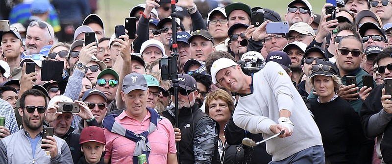 International team member Adam Scott of Australia plays from the rough on the 15th hole at Royal Melbourne Golf Club during a fourball match at the Presidents Cup on Saturday. / AP photo by Andy Brownbill