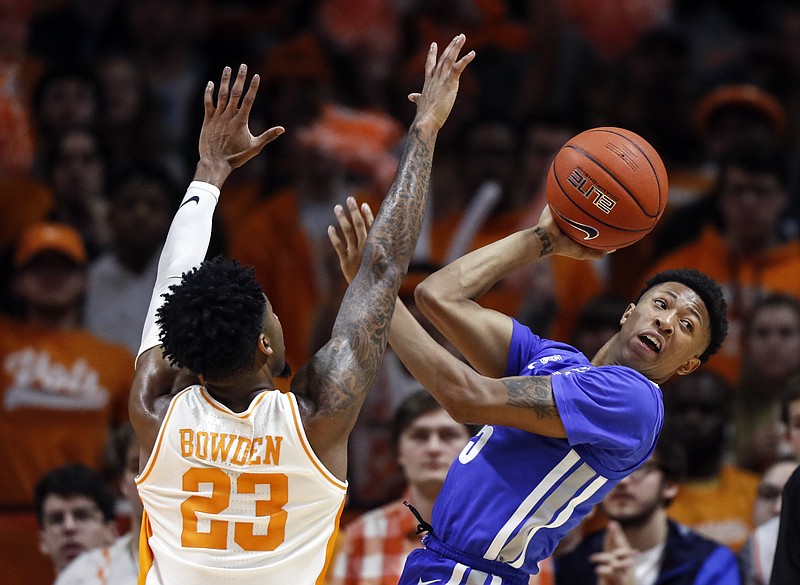 Memphis guard Boogie Ellis passes the ball while guarded by Tennessee's Jordan Bowden during the first half of Saturday's game in Knoxville. Ellis helped the Tigers win 51-47, ending a streak of Vols victories at Thompson-Boling Arena that had reached 31 games. / AP photo by Wade Payne