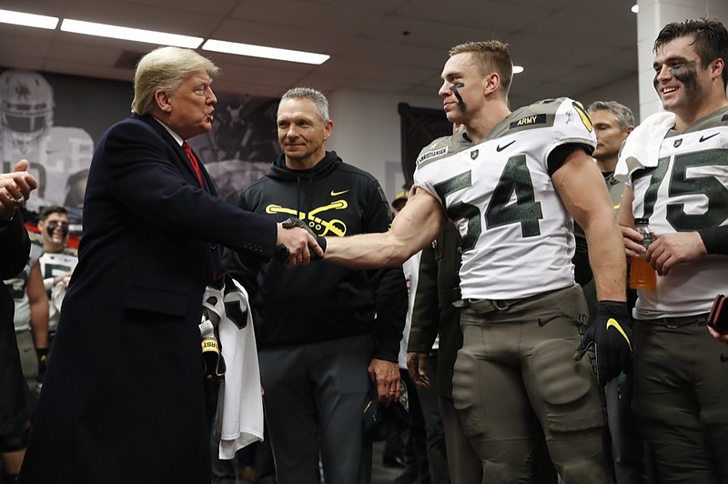 President Donald Trump shakes hands with Army football player Cole Christiansen before the Black Knights' rivalry game against Navy on Saturday in Philadelphia. / AP photo by Jacquelyn Martin

