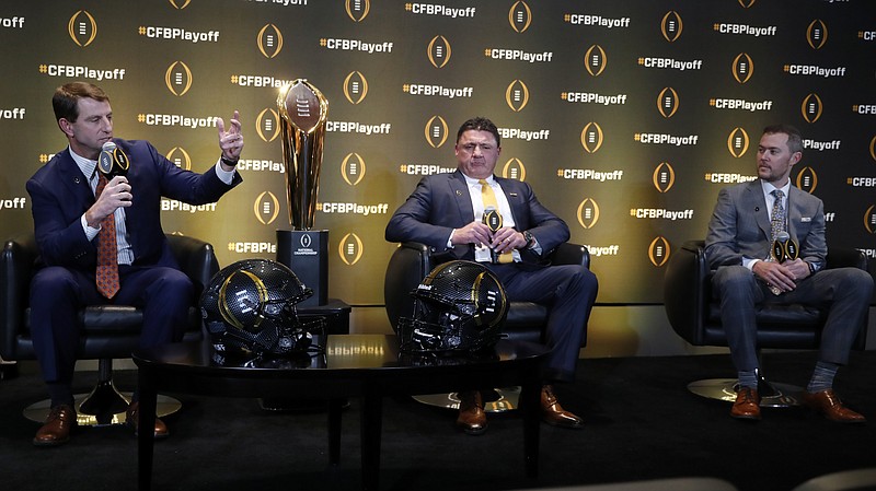 Three of the four coaches whose teams are in the upcoming College Football Playoff spoke to the media on Thursday at the College Football Hall of Fame in Atlanta. From left are Clemson's Dabo Swinney, LSU's Ed Orgeron and Oklahoma's Lincoln Riley. Ohio State's Ryan Day was unable to attend because of travel delays. / AP photo by John Bazemore