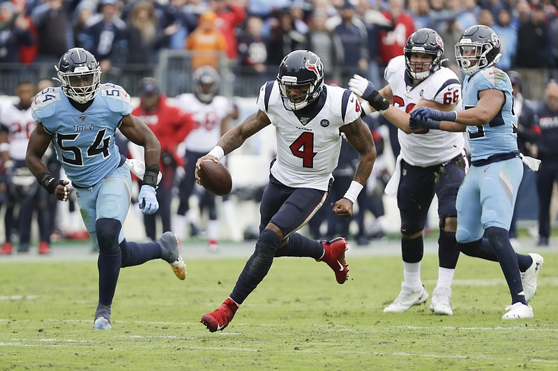 Houston Texans quarterback Deshaun Watson scrambles away from Tennessee Titans defenders in the second half of Sunday's game in Nashville. The Texans won 24-21. / AP photo by James Kenney