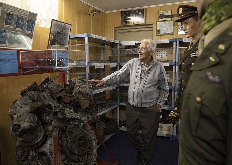 In this photo taken on Thursday, Nov. 7, 2019, Marcel Schmetz shows the motor of a crashed World War II Marauder B-26 at the Remember Museum 39-45 in Thimister-Clermont, Belgium. The museum houses countless World War II objects, but it's most important collection are stories and photos of those who served in World War II, mostly during the Battle of the Bulge. Veterans of the WWII Battle of the Bulge are heading back to mark, perhaps the greatest battle in U.S. military history, when 75-years ago Hitler launched a desperate attack deep through the front lines in Belgium and Luxembourg to be thwarted by U.S. forces.(AP Photo/Virginia Mayo)