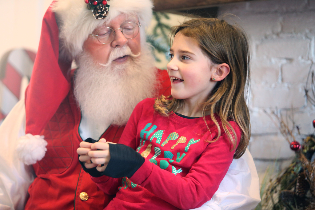 Staff photo by Erin O. Smith / Kennedy Ford, 7, tells Santa what she wants for Christmas during the Christmas in the Streets Block Party Saturday, December 14, 2019 in Chickamauga, Georgia. Ford requested LOL dolls.