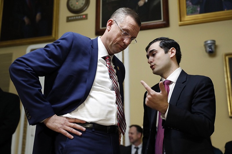 House Judiciary Committee ranking member Rep. Doug Collins, R-Ga., speaks to an aide before a House Rules Committee hearing on the impeachment against President Donald Trump, Tuesday, Dec. 17, 2019, on Capitol Hill in Washington. (AP Photo/Andrew Harnik, Pool)