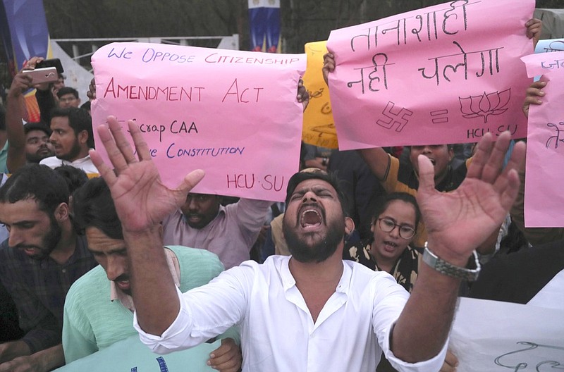 Indian Hyderabad Central University (HCU) students shout slogans during a protest rally against a new citizenship law in Hyderabad, India, Monday, Dec.16, 2019. The new law gives citizenship to non-Muslims who entered India illegally to flee religious persecution in several neighboring countries. (AP Photo/Mahesh Kumar A.)