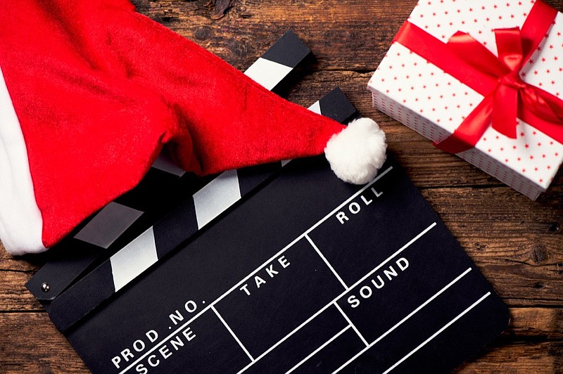 Christmas hat with film board cutout christmas movie tile holiday film tile santa hat film filmmaker / Getty Images
