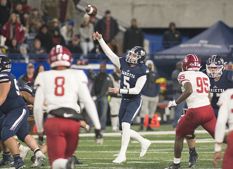 Marietta senior Harrison Bailey passes during the GHSA Class AAAAAAA title game against Lowndes last Saturday at Georgia State Stadium in Atlanta. The 6-foot-5, 211-pound Bailey, who quarterbacked the Blue Devils to a 17-9 win that night for the program's first state championship since 1967, signed with Tennessee on Wednesday. / Marietta Daily Journal photo by Anthony Stalcup