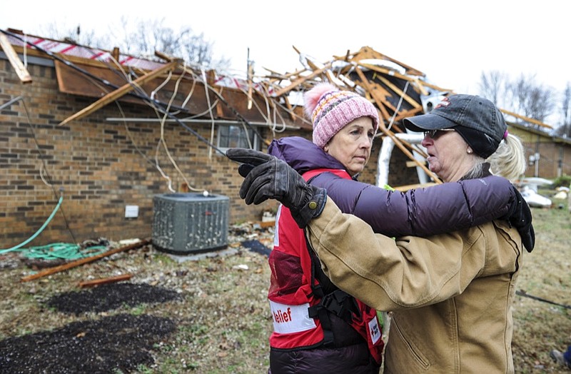Cathie Morris, right, tells Red Cross volunteer Laurie Howell on Tuesday, December 17, 2019 that her sister was killed by one of the April 2011 tornadoes, not far from what they're standing, in front of Morris' house, damaged by the Monday, December 16, 2019 storms off Neely Hill Loop in Limestone County, Ala. (Jeronimo Nisa/The Decatur Daily via AP)

