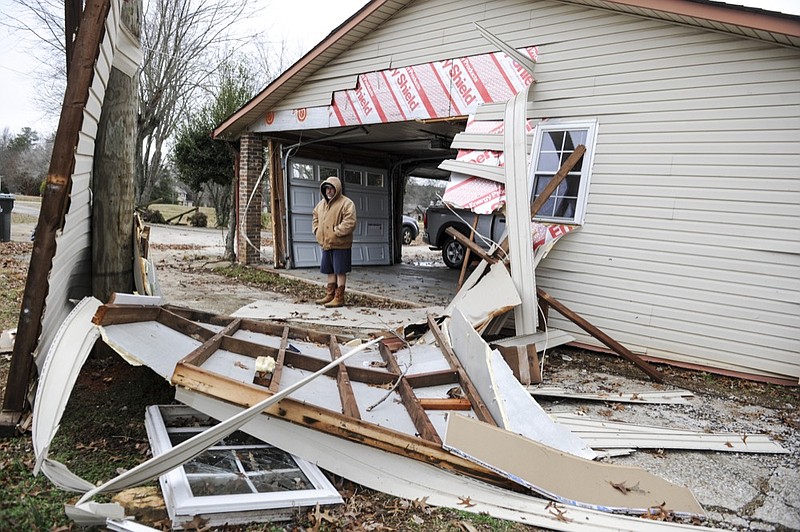 Johnny Carter stands by a section of his residence on Moyers Road damaged by the Monday, December 16 storm in Limestone County, Ala., Tuesday, Dec. 17, 2019Carter and his family moved to this house after they were seriously injured by the 2014 tornado in the Clements, Ala. Community. (Jeronimo Nisa/The Decatur Daily via AP)

