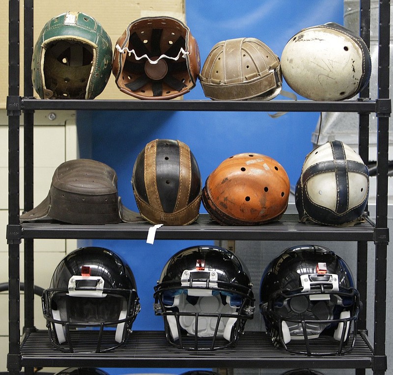 Various football helmets used for testing helmet-to-helmet collisions are displayed on a rack at a laboratory in the Cleveland (Ohio) Clinic's Lutheran Hospital on Sept. 23, 2010. Helmets have evolved from the original hard leather of the NFL's infancy to hard polycarbonate single-piece shells with various amounts of padding and air bladders that served as the primary form of head protection into the beginning of this century. / AP photo by Mark Duncan

