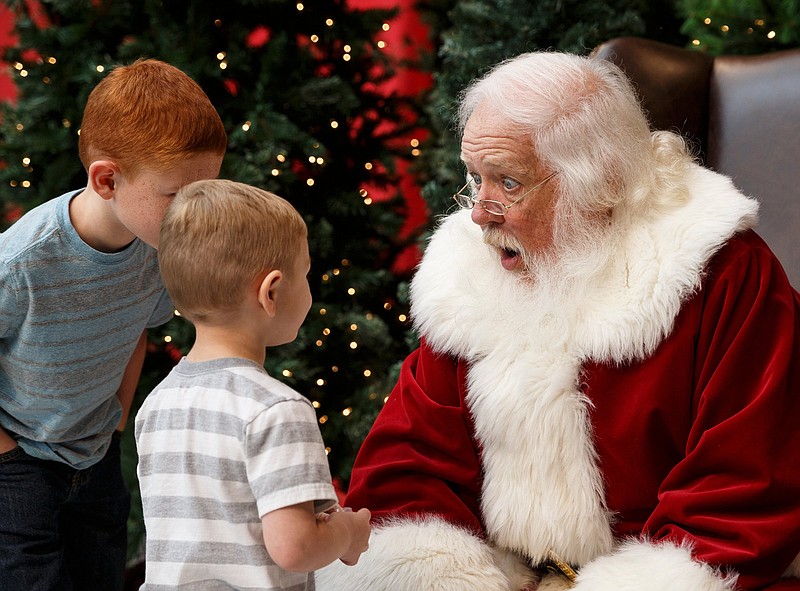 Santa responds as Emerson Hughes, left, and Jesse Hughes tell him what they want for Christmas during the Chattanooga Times Free Press's annual HoHo Expo at the Chattanooga Convention Center on Saturday, Nov. 17, 2018, in Chattanooga, Tenn. Staff file photo. 
