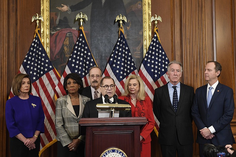 House Speaker Nancy Pelosi, left, and other Democratic members of the U.S. House unveil articles of impeachment against President Donald Trump earlier this month.