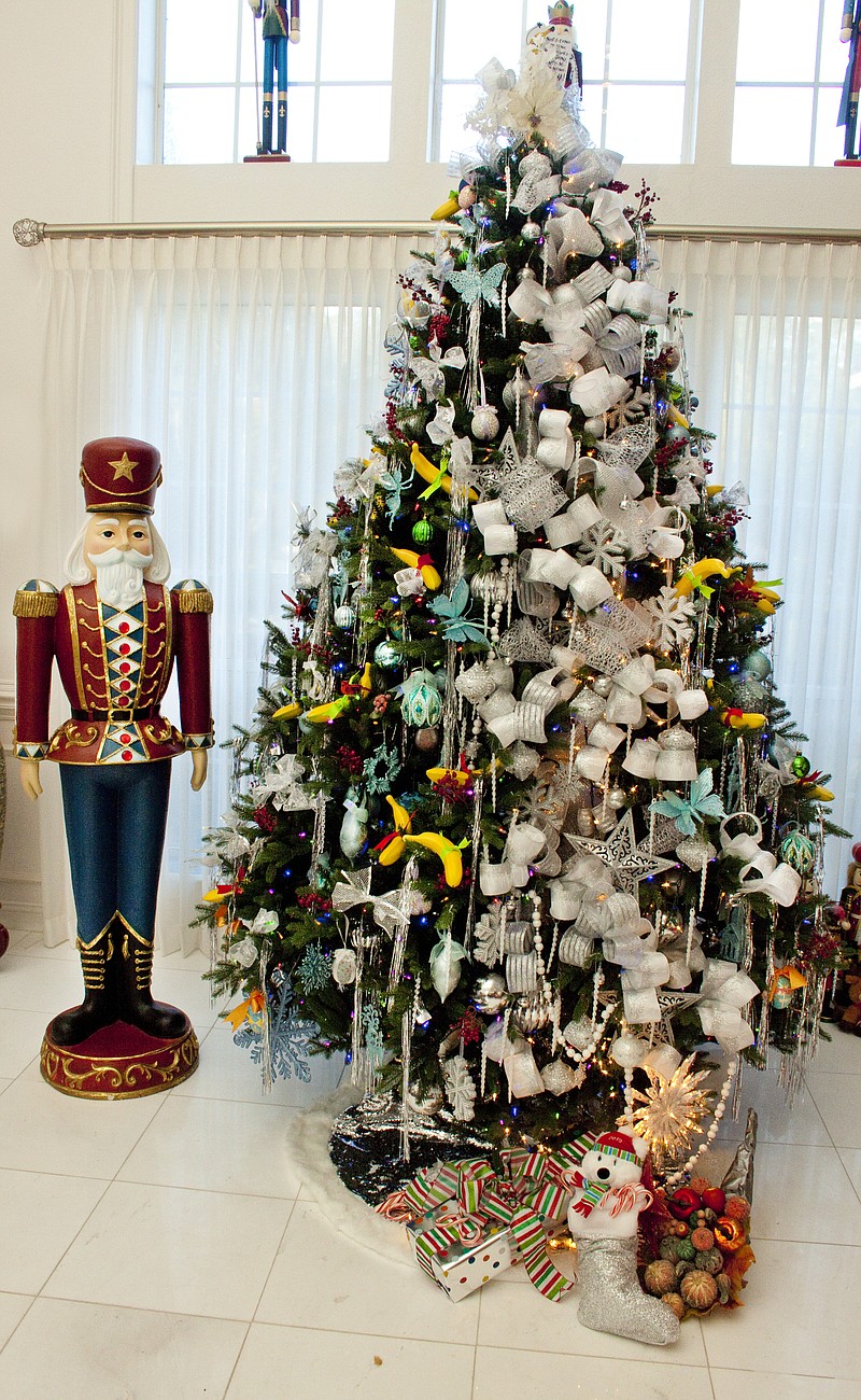 Photo by KJ Photography/Kelly George / Artist Byron Keith Byrd's Banana Christmas Tree features 36 plastic bananas and the artist's signature "ribbon spill," done in winter whites and silver to contrast with client Kathryn Buffington's collection of family ornaments. Some of her collection of Nutcrackers are situated around the room.