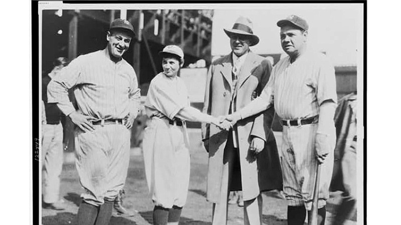 Jackie Mitchell and Babe Ruth shake hands as Lou Gehrig, left, and Joe Engel look on. / Photo courtesy of Library of Congress