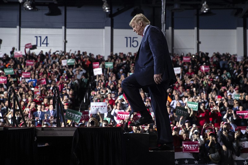 FILE - In this Wednesday, Dec. 18, 2019 file photo, President Donald Trump arrives at W.K. Kellogg Airport to attend a campaign rally in Battle Creek, Mich. (AP Photo/Evan Vucci, File)