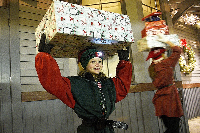 Staff Photo by Robin Rudd/  Elf, Emily Pierce balances a present on her head.  Tennessee Valley Railroad Museum's North Pole Limited arrives at the East Chattanooga station, renamed for the North Pole on December 19, 2019.  The ride features Santa, decorations and the antics of trackside elves.  The museum will run the train until the night of the 23rd and a few evenings after Christmas.         