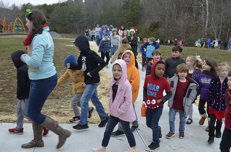 North Hamilton County Elementary students do a lap around the school's new walking track. Students successfully raised the money to build the track after narrowly losing a contest in which a new walking track was the prize. / Staff photo by Emily Crisman