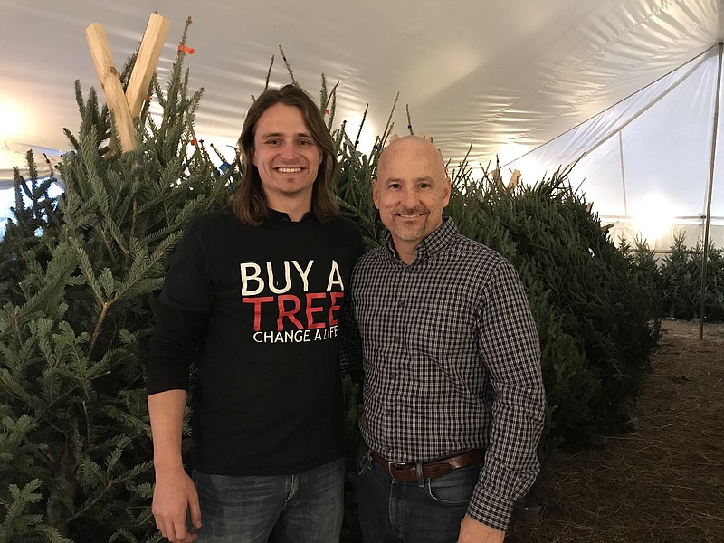 Staff photo by Sabrina Bodon / Coleman and Tim Bailey man the Christmas tree sale at Mercy Ridge Church in Rossville. Their "Buy a Tree, Change a Life" event raised over $10,200.