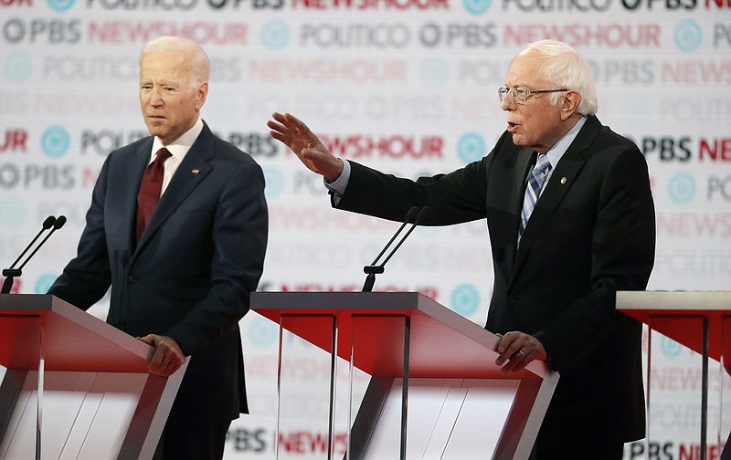 The Associated Press / Former Vice President Joe Biden, left, is happy to stand quietly as the current poll leader while U.S. Sen. Bernie Sanders, I-Vermont, rattles on during Thursday's Democratic presidential primary debate.