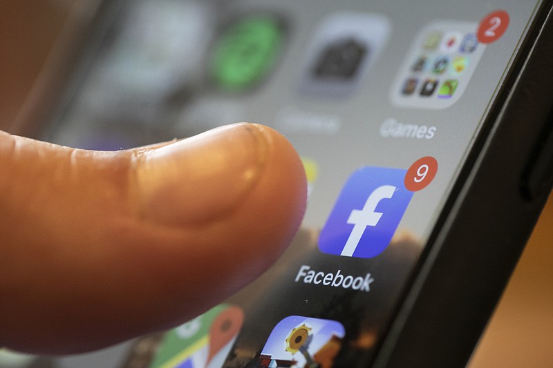 In this Aug. 11, 2019, file photo an iPhone displays the Facebook app in New Orleans. Facebook says it won't allow interference with the U.S. census on its platform, including posting misleading information about when and how to participate, who can participate and the consequences of taking part. (AP Photo/Jenny Kane, File)