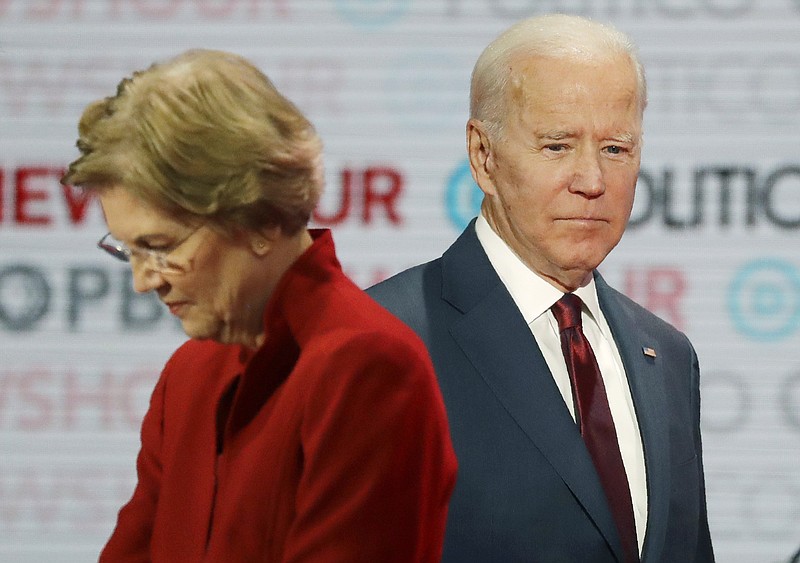Democratic presidential candidates Sen. Elizabeth Warren, D-Mass., left, and former Vice President Joe Biden stand on stage during a break at a Democratic presidential primary debate Thursday, Dec. 19, 2019, in Los Angeles. (AP Photo/Chris Carlson)