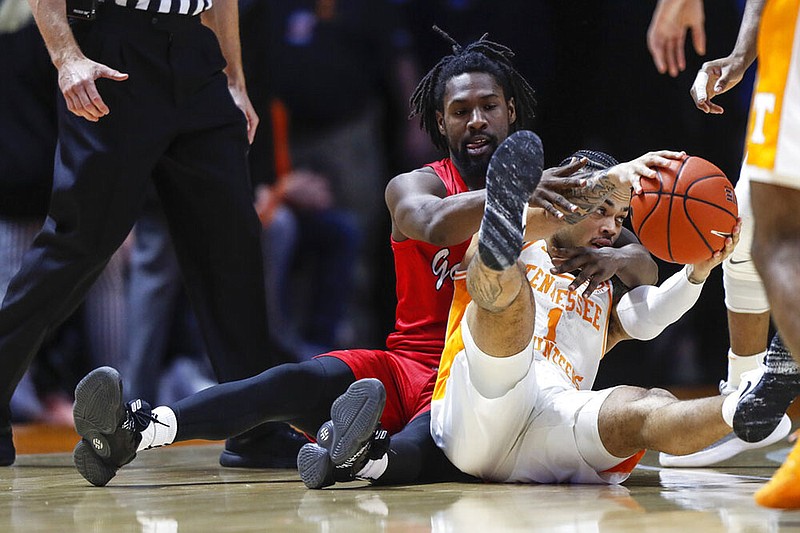 Tennessee's Lamonte Turner keeps the ball away from Jacksonville State's Ty Hudson during the first half of Saturday's game in Knoxville. / AP photo by Wade Payne