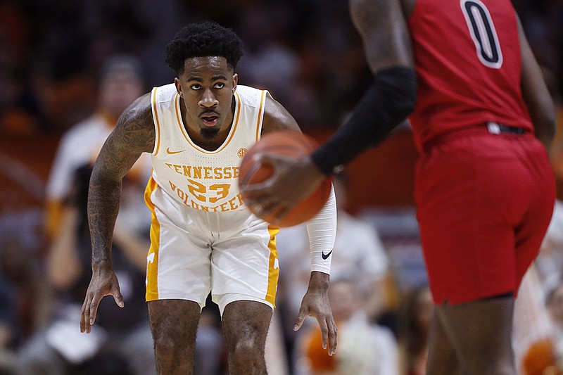 Tennessee senior guard Jordan Bowden crouches into a defensive stance as Jacksonville State guard Derrick Cook dribbles during Saturday's game in Knoxville. / AP photo by Wade Payne
