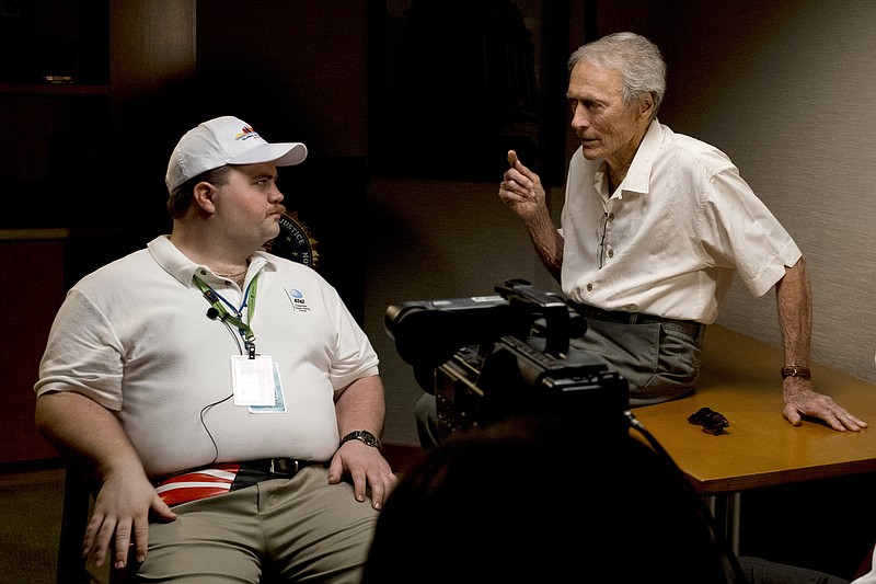 "Richard Jewell" director Clint Eastwood, right, talks with actor Paul Walter Hauser, who portrays the hero-turned-suspect in the 1996 Atlanta Centennial Park bombing. (Claire Folger/Warner Bros. Pictures via AP)