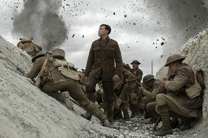 This image released by Universal Pictures shows George MacKay, center, in a scene from "1917," directed by Sam Mendes. (Francois Duhamel/Universal Pictures via AP)