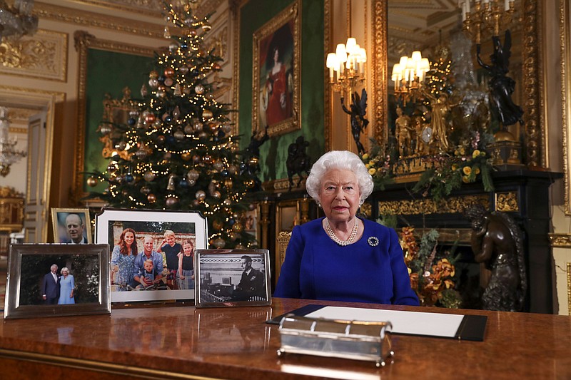 In this image released Tuesday Dec. 24, 2019, Britain's Queen Elizabeth II poses for a photo, while recording her annual Christmas Day message to the nation, at Windsor Castle, England. Excerpts released by Buckingham Palace of the pre-recorded message to be broadcast on TV on Christmas Day, show the Queen acknowledging that both Britain and her family have endured a difficult year. (Steve Parsons/pool via AP)