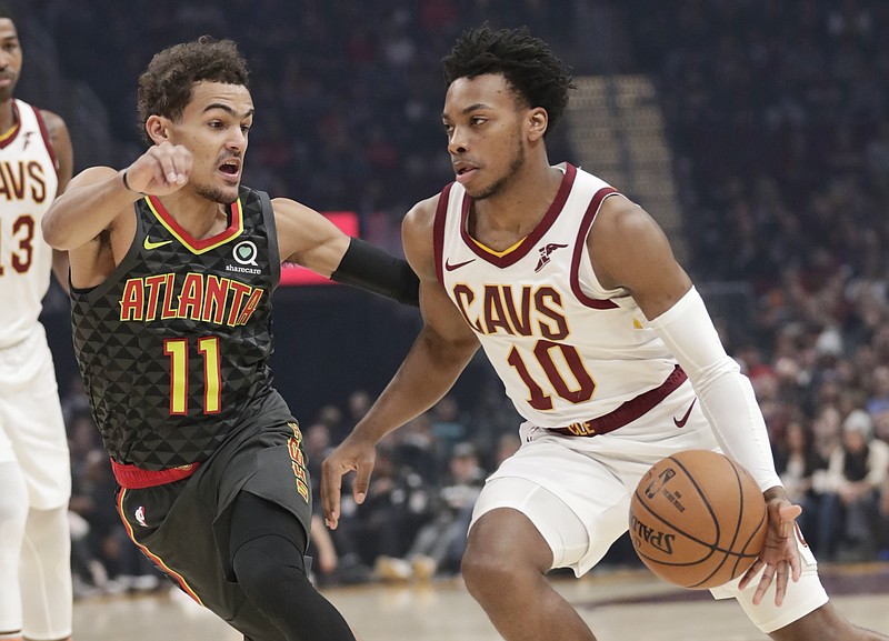 Cleveland Cavaliers' Darius Garland (10) drives past Atlanta Hawks' Trae Young (11) during the first half of an NBA basketball game Monday, Dec. 23, 2019, in Cleveland. (AP Photo/Tony Dejak)
