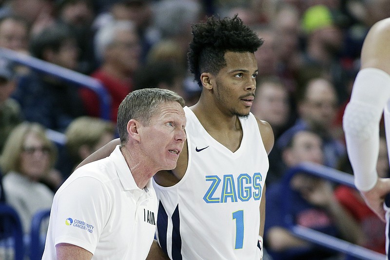 Gonzaga head coach Mark Few, left, speaks with guard Admon Gilder (1) during the second half of an NCAA college basketball game against Eastern Washington in Spokane, Wash., Saturday, Dec. 21, 2019. Gonzaga won 112-77. (AP Photo/Young Kwak)