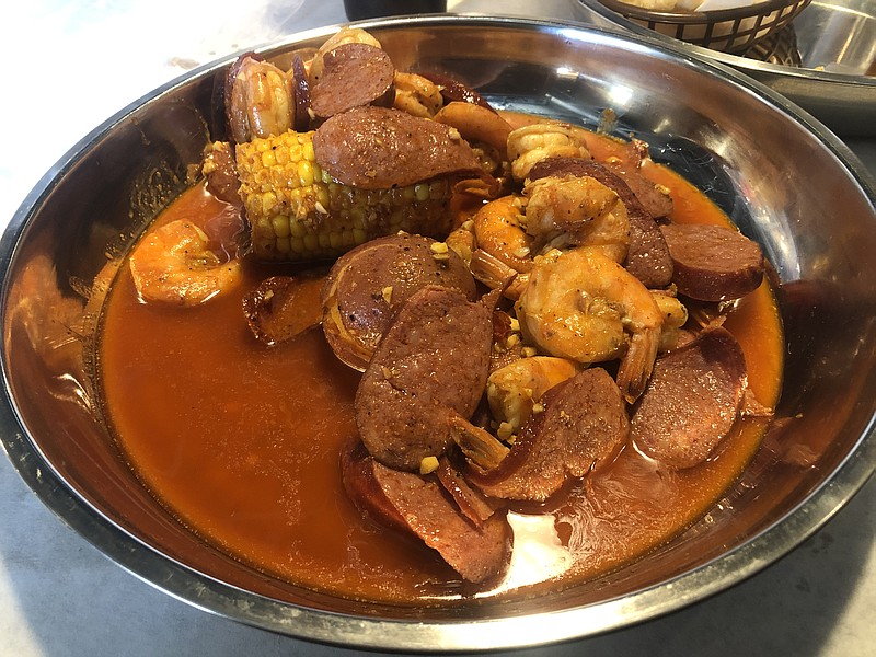 Headless shrimp and smoked sausage boiled with medium Juicy Special Sauce, which is a combination of Cajun, lemon pepper and garlic butter. / Photo by Jim Tanner