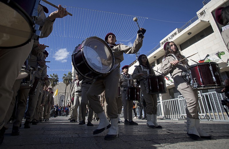 A Palestinian Scout marching band parades during Christmas celebrations outside the Church of the Nativity, built atop the site where Christians believe Jesus Christ was born, on Christmas Eve, in the West Bank City of Bethlehem, Tuesday, Dec. 24, 2019. (AP Photo/Majdi Mohammed)