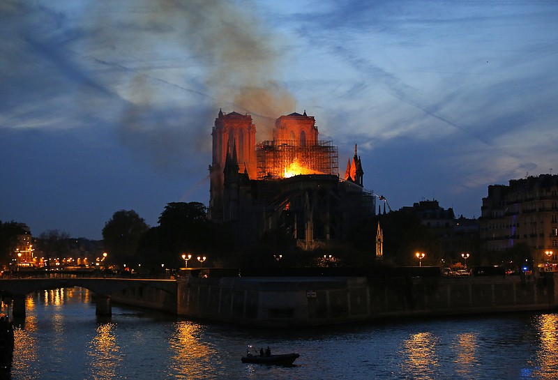 Flames and smoke rise from Notre Dame cathedral in Paris as firefighters tackle the blaze on April 15, 2019. (AP Photo/Michel Euler)