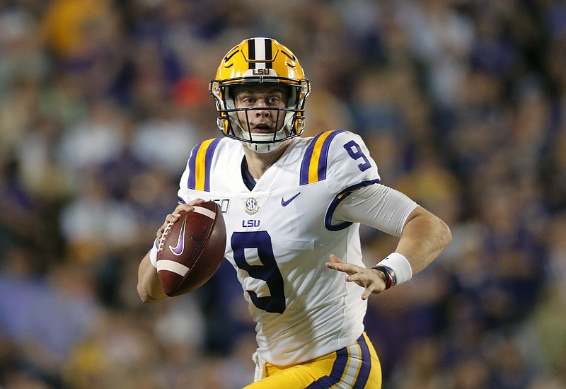 FILE - In this Nov. 30, 2019, file photo, LSU quarterback Joe Burrow (9) scrambles during the first half of an NCAA college football game against Texas A&M, in Baton Rouge, La. LSU quarterback Joe Burrow is The Associated Press college football player of the year in a landslide vote.  Burrow, who has led the top-ranked Tigers to an unbeaten season and their first College Football Playoff appearance, received 50 of 53 first-place votes from AP Top 25 poll voters and a total of 156 points.  (AP Photo/Gerald Herbert, File)