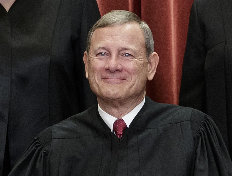 This Nov. 30, 2018, file photo shows Chief Justice of the United States, John G. Roberts, as he sits with fellow Supreme Court justices for a group portrait at the Supreme Court Building in Washington. Roberts will move from the camera-free, relative anonymity of the Supreme Court to the glare of television lights in the Senate to preside over President Donald Trump's impeachment trial. (AP Photo/J. Scott Applewhite, File)