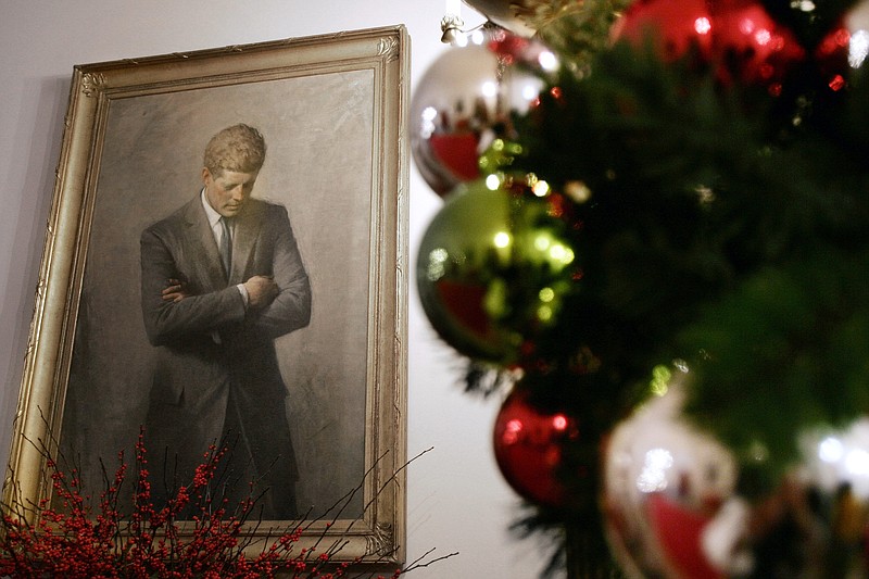 FILE - In this Nov. 30, 2006, file photo, a portrait of former President John F. Kennedy, framed by Christmas decorations, hangs in the White House in Washington. A copy of Kennedy's 1961 letter reassuring an 8-year-old Michigan girl, who had written him concerned that Santa would be killed if Russia tested a nuclear bomb at the North Pole, is being featured in December 2019 at the JFK Presidential Library and Museum in Boston. (AP Photo/Ron Edmonds, File)