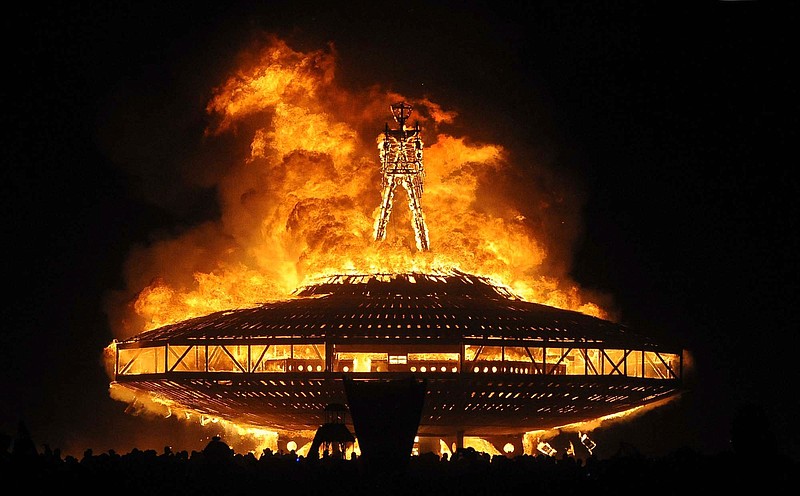 In this Aug. 31, 2013 file photo, the "Man" burns on the Black Rock Desert at Burning Man near Gerlach, Nev. Burning Man organizers sued the U.S. Bureau of Land Management to recover millions of dollars they say the government has overcharged them in fees over the past seven years at the counter-culture celebration in the Nevada desert. Black Rock City LLC, the nonprofit that produces the annual Burning Man event, filed the lawsuit Dec. 13, 2019 in U.S. District Court in Washington. (Andy Barron/The Reno Gazette-Journal via AP, File)