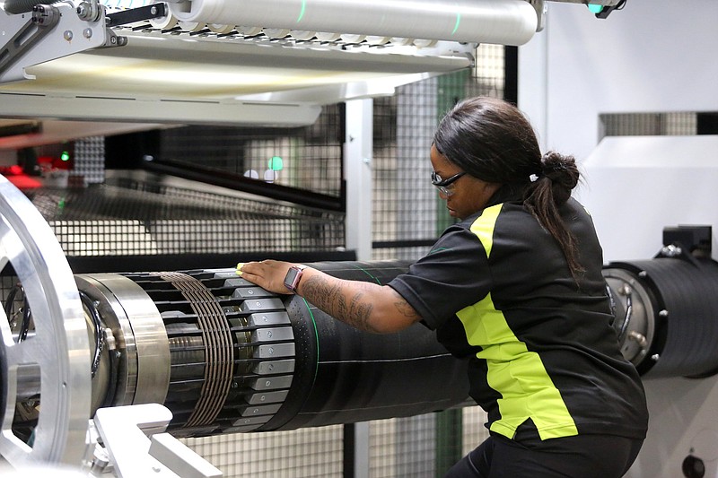 Staff file photo by Erin O. Smith / Shikela Ray, a tire building machine operator, works at a machine during the grand opening event for the Nokian Tyres production plant in Dayton, Tennessee.