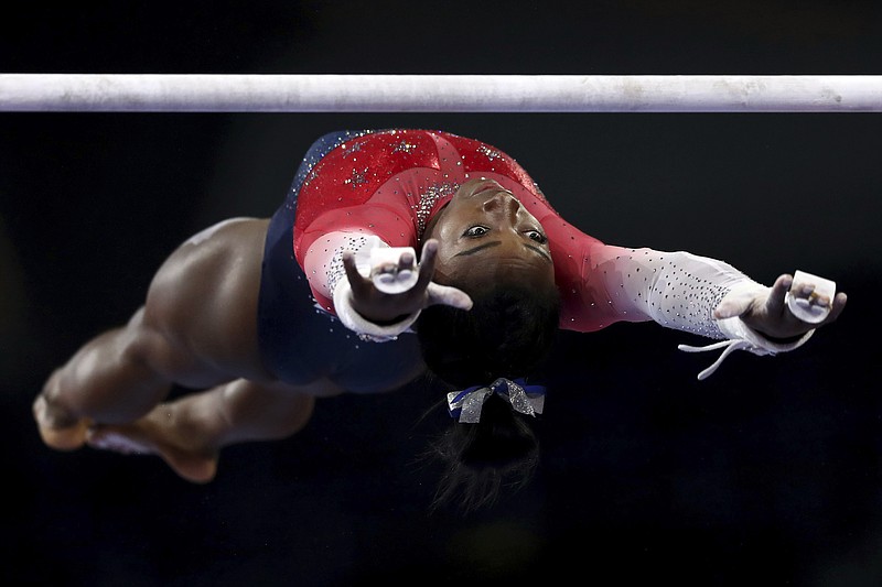 U.S. gymnast Simone Biles warms up on the uneven bars during the women's team final at the world championships on Oct. 8 in Stuttgart, Germany. / AP photo by Matthias Schrader