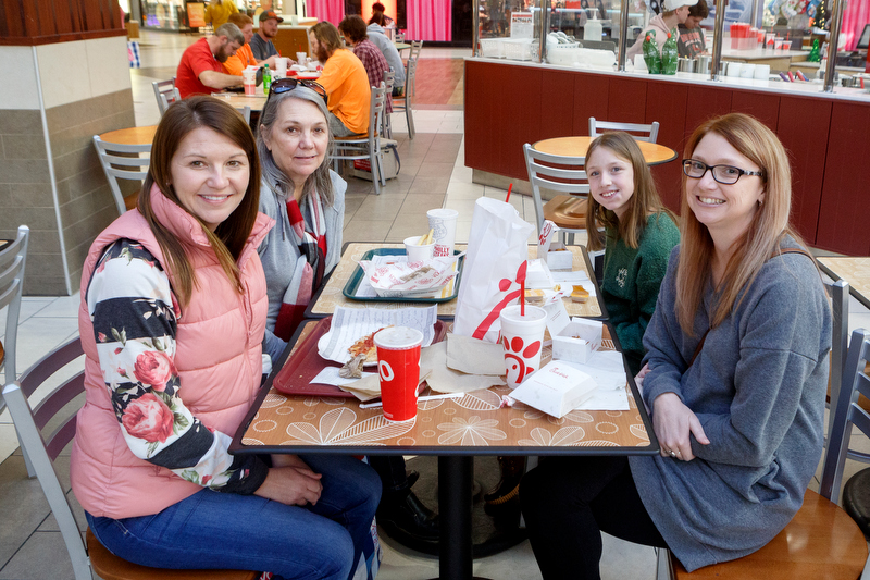 Staff photo by C.B. Schmelter / (Clockwise from top left) Janet Middlebrooks, 62, Brandie Kay, 36, Brittney Grooms, 31, and Kylie Grooms, 11, pose at Hamilton Place Mall on Thursday, Dec. 26, 2019 in Chattanooga, Tenn. The group had gift cards to break in and wanted to take advantage of the sales. "You get more for your money," Kay said.