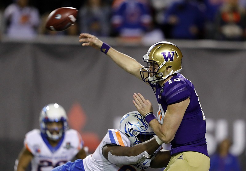 Washington quarterback Jacob Eason passes under pressure from Boise State nose tackle Scale Igiehon during the Las Vegas Bowl last Saturday. Eason, a redshirt junior this season, will not return for the Huskies in 2020, choosing instead to pursue a pro football career. / AP photo by Steve Marcus